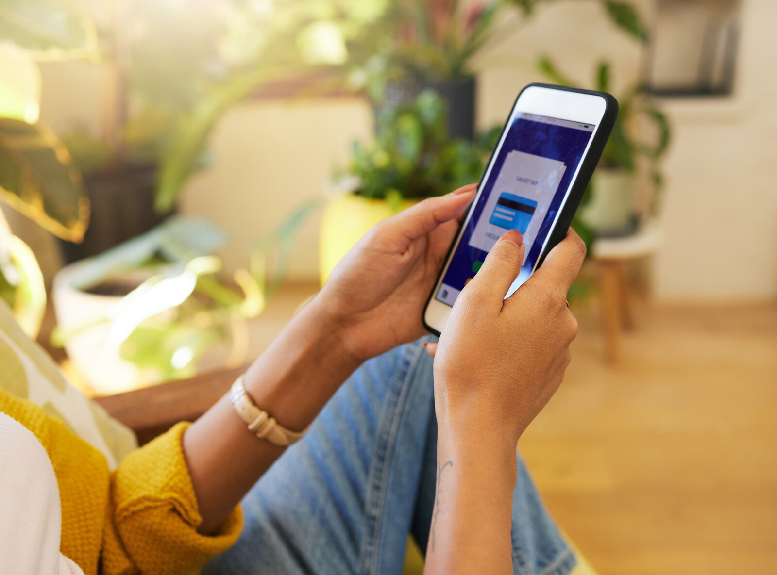 Chime banking app everyday use Person using a mobile banking app on a phone at home