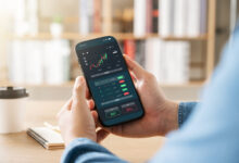 Person using the Robinhood investing app on a phone to claim a free stock referral bonus
