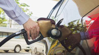Driver filling a car at a gas station pump, representing Upside cash back on gas